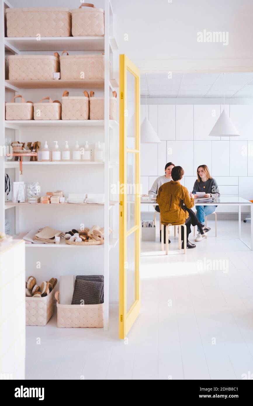 Female fashion designers having discussion in workshop Stock Photo