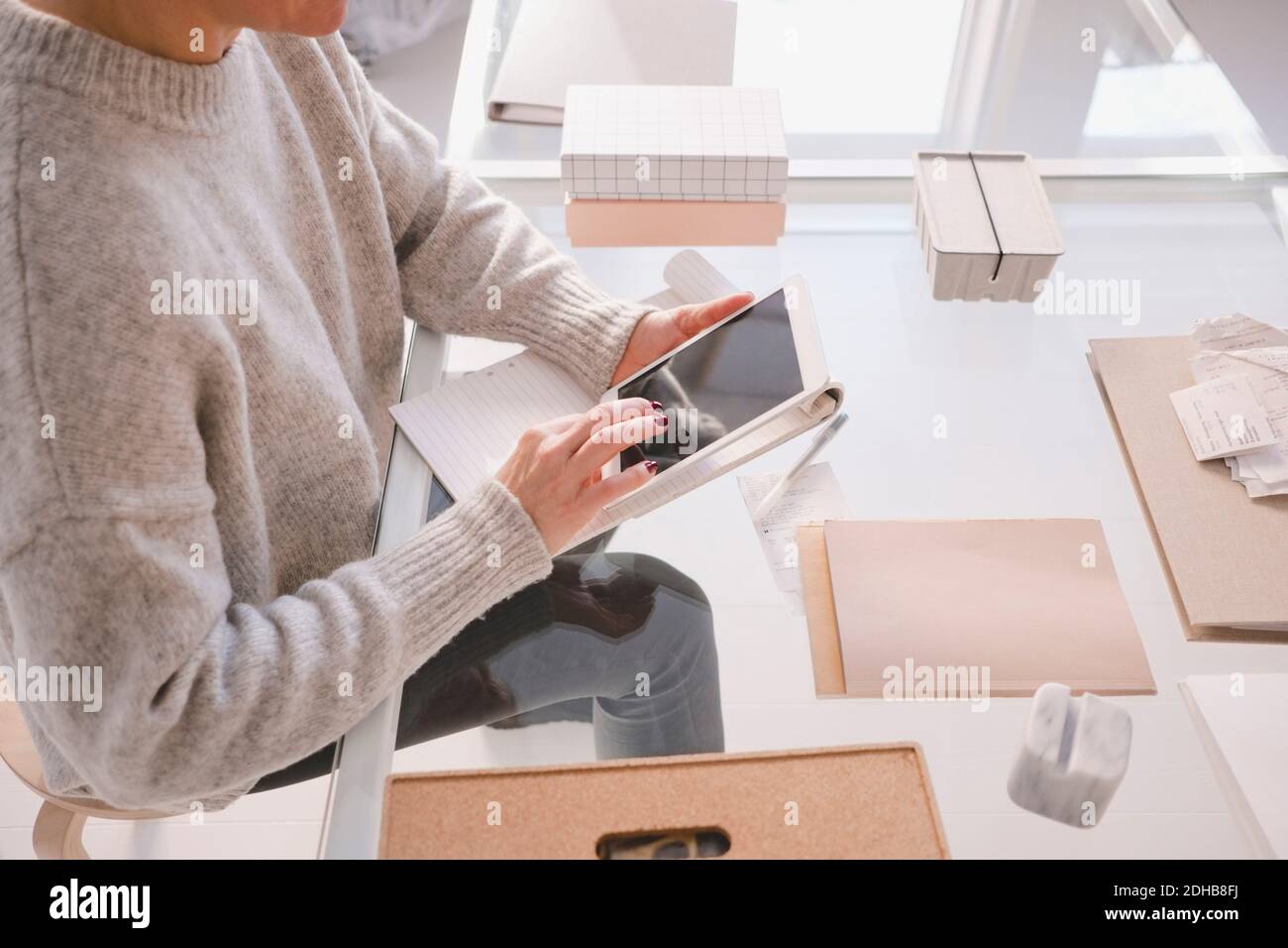 High angle view of female interior designer using digital tablet at desk in store Stock Photo