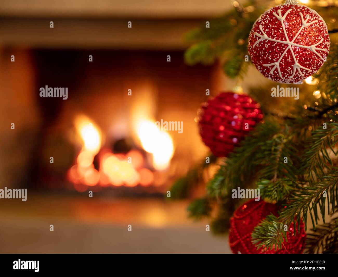 Christmas tree, burning fireplace background. Warm cozy Xmas holiday ...