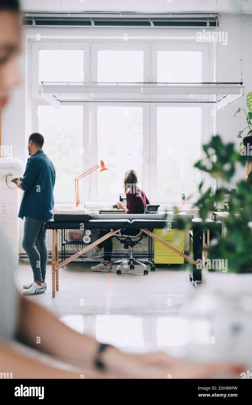 Businessman and businesswoman working in creative office Stock Photo