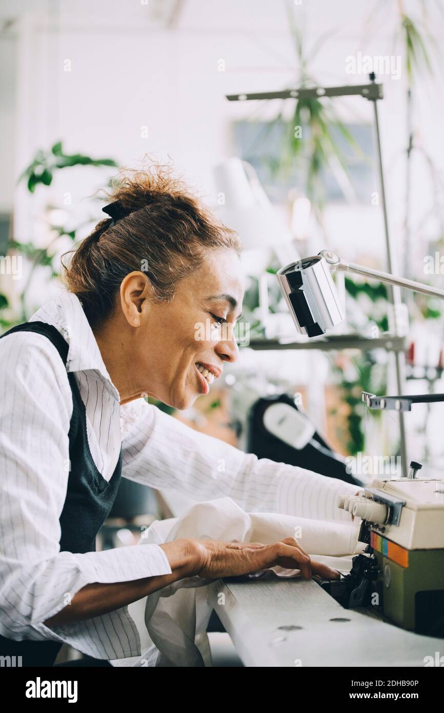 Smiling businesswoman working in creative office Stock Photo