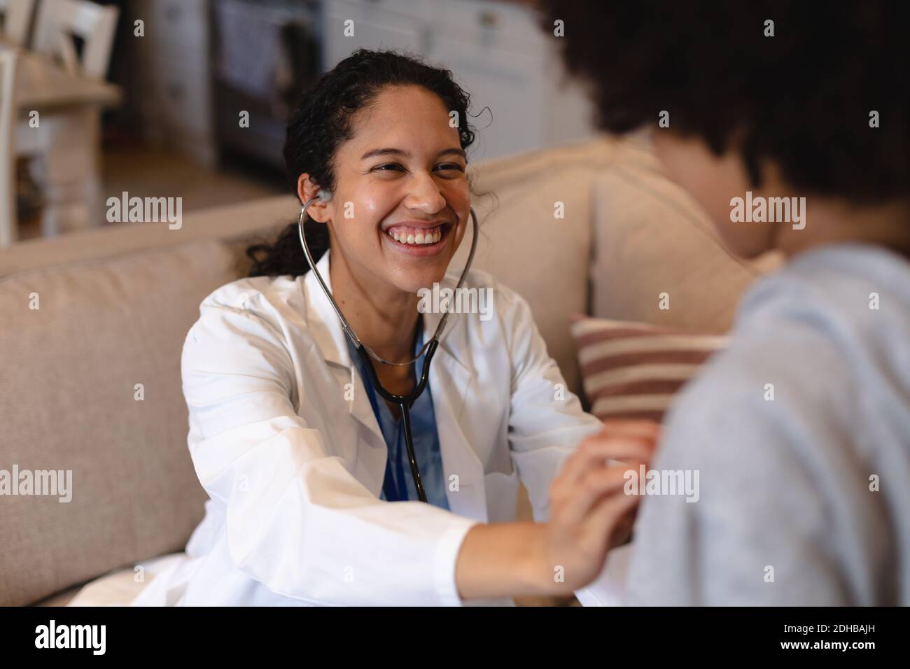 Mixed race girl being examined by mixed race female doctor Stock Photo