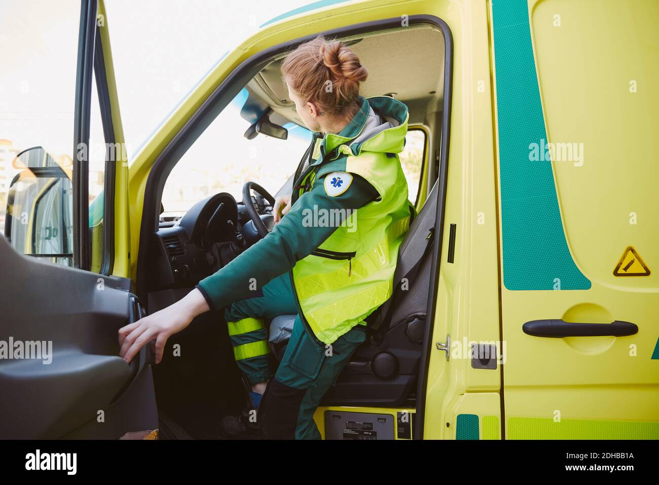 Female paramedic closing door of ambulance Stock Photo