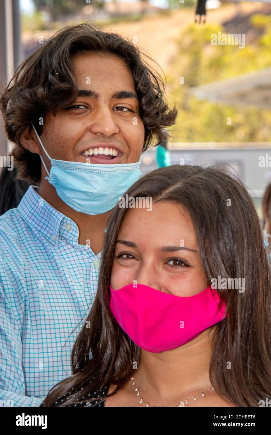 Hispanic and Caucasian students wear face masks due to the coronavirus