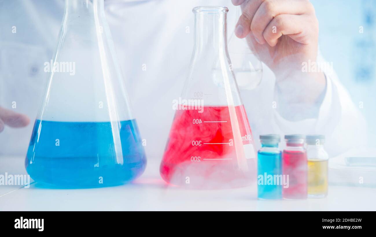 Funny mad chemist working in a laboratory Stock Photo