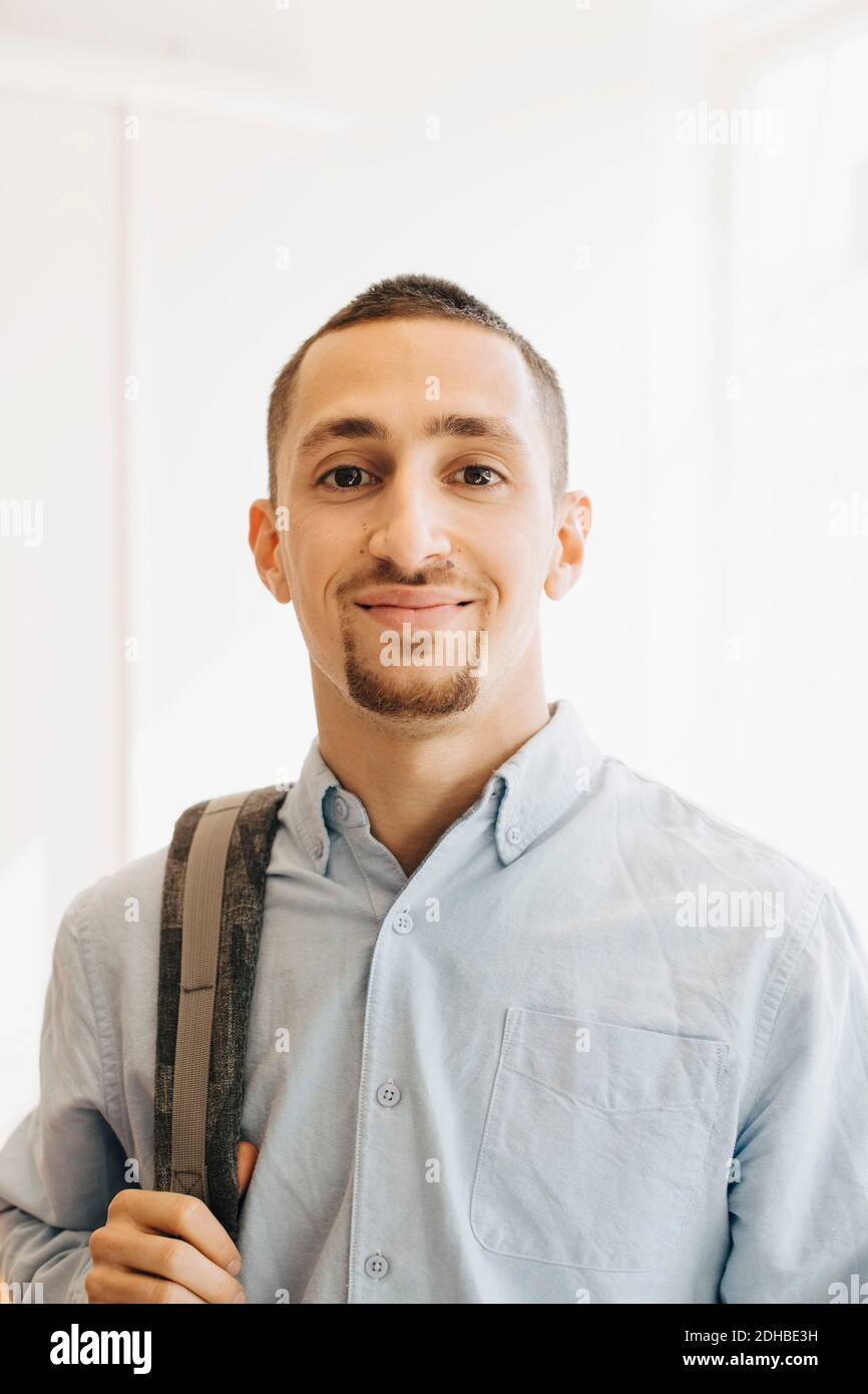 Portrait of smiling IT programmer standing in office Stock Photo