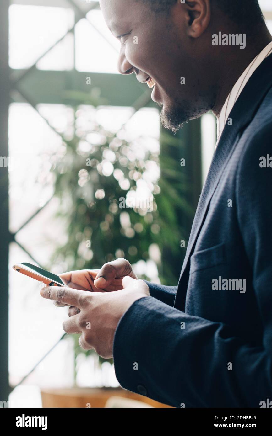 Businessman using mobile phone at office Stock Photo