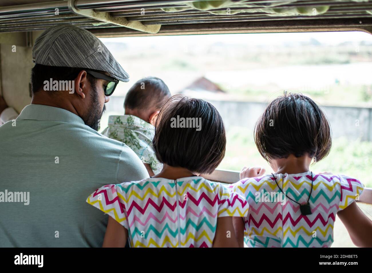 Yangon, Myanmar - December 31, 2019: A family  looks out over the view from the traditional circle train in Yangon Stock Photo