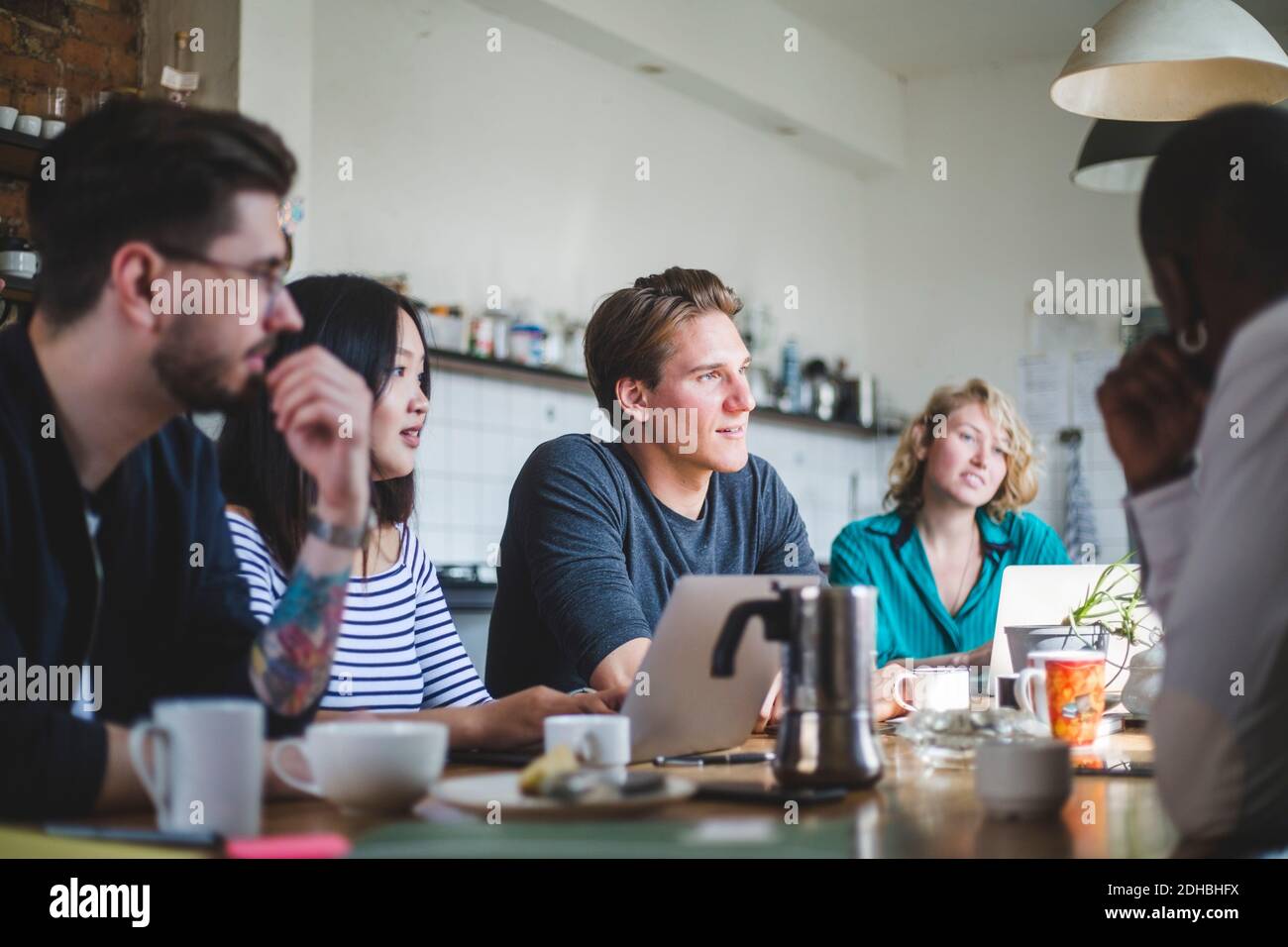Young IT experts looking away at creative workplace Stock Photo