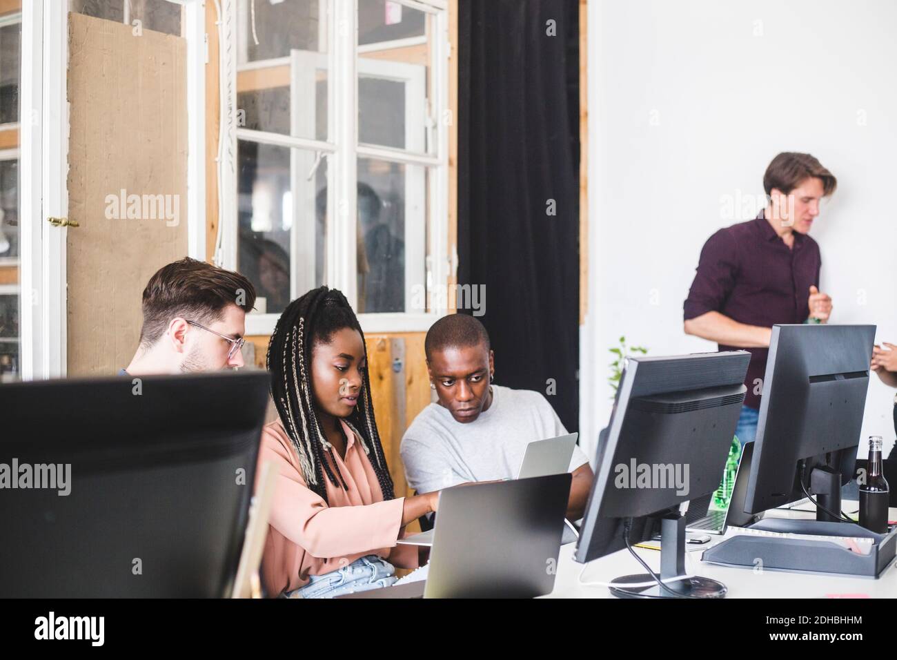 Team of confident young computer programmers working on new project in ...