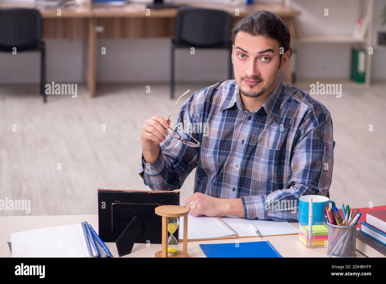 Young male student sitting in the classroom Stock Photo - Alamy