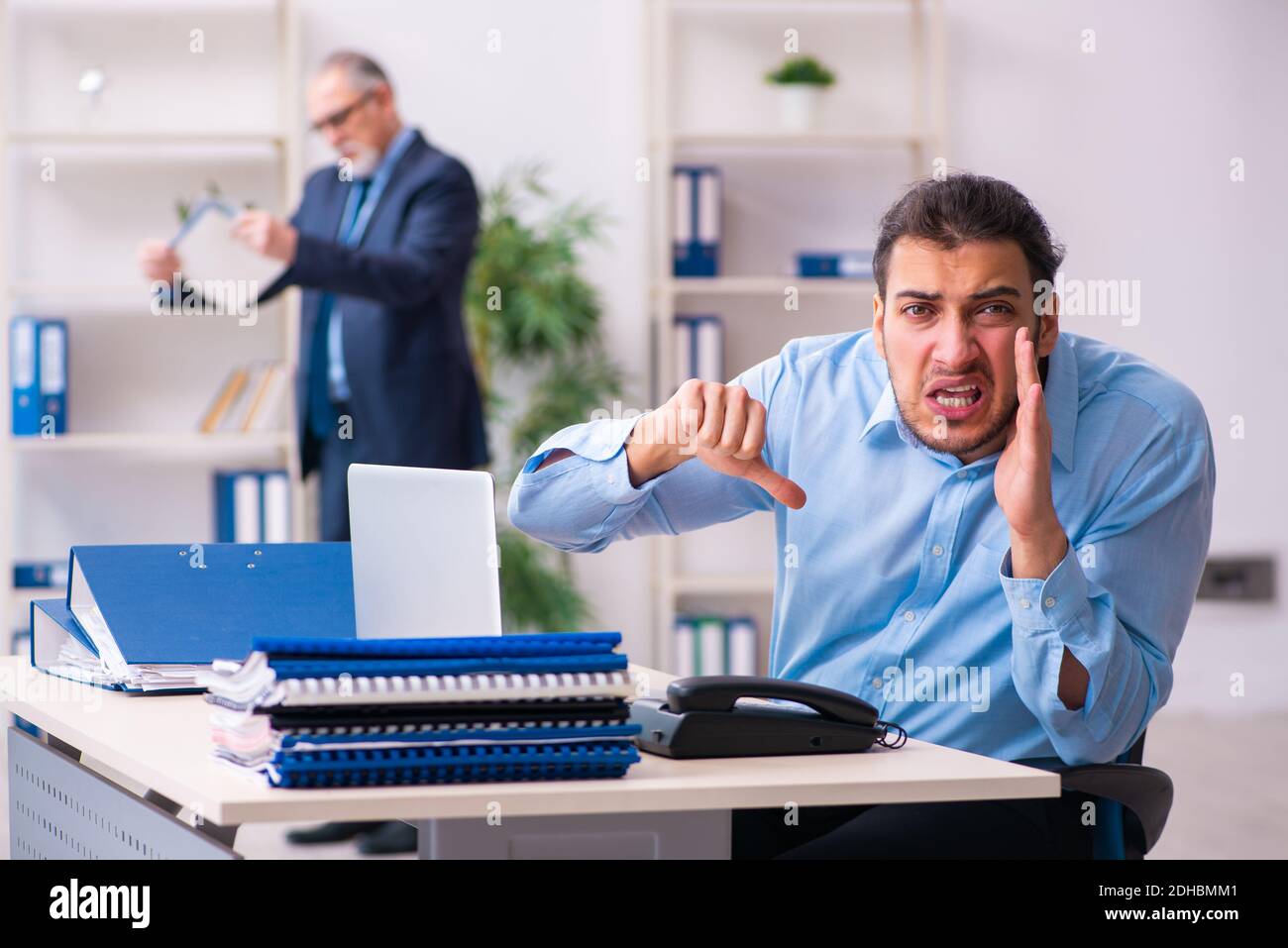 Old boss and his young assistant in the office Stock Photo - Alamy
