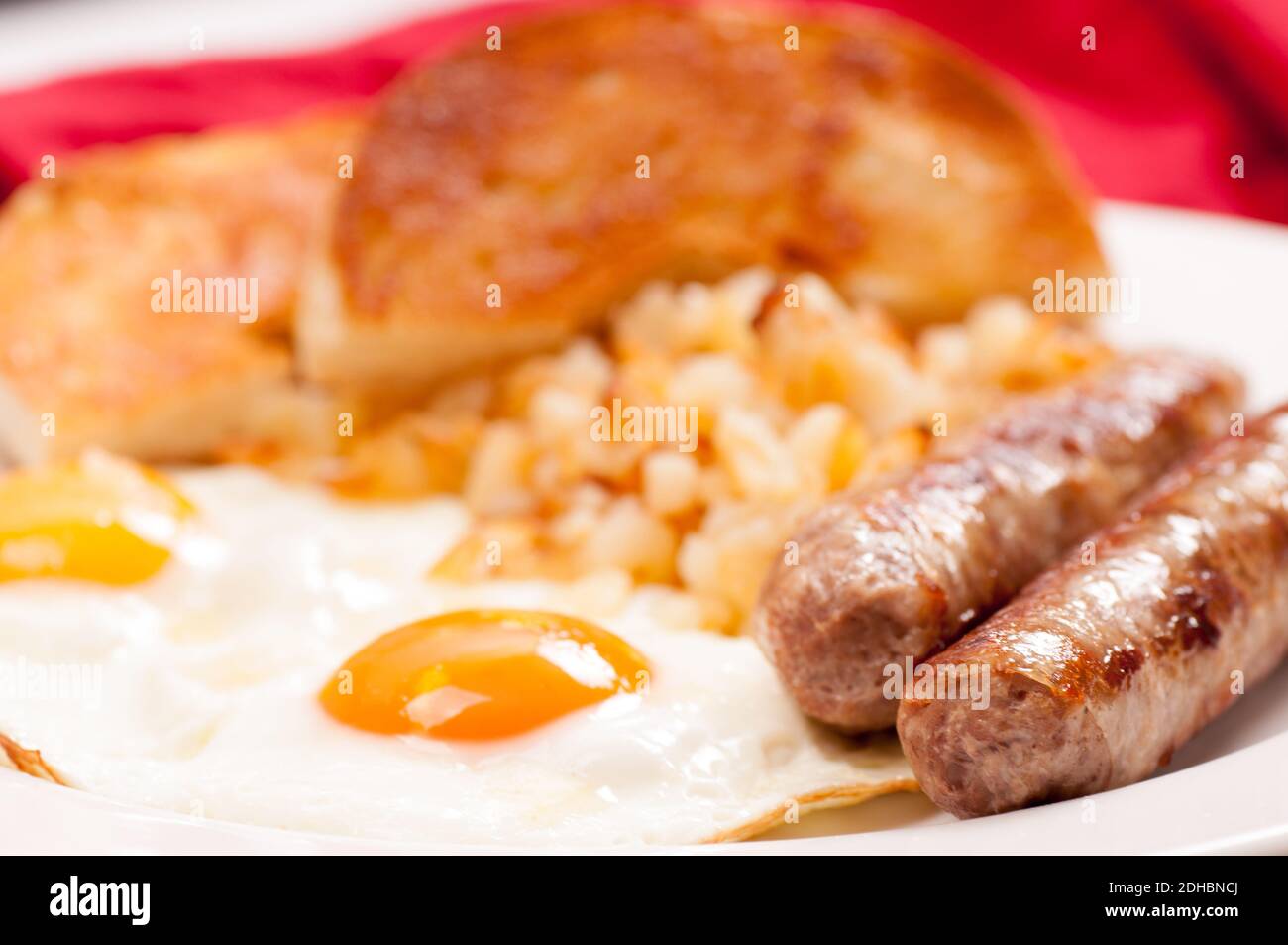 2 eggs with different colored yolks, plus sausage and bagel Stock Photo Alamy