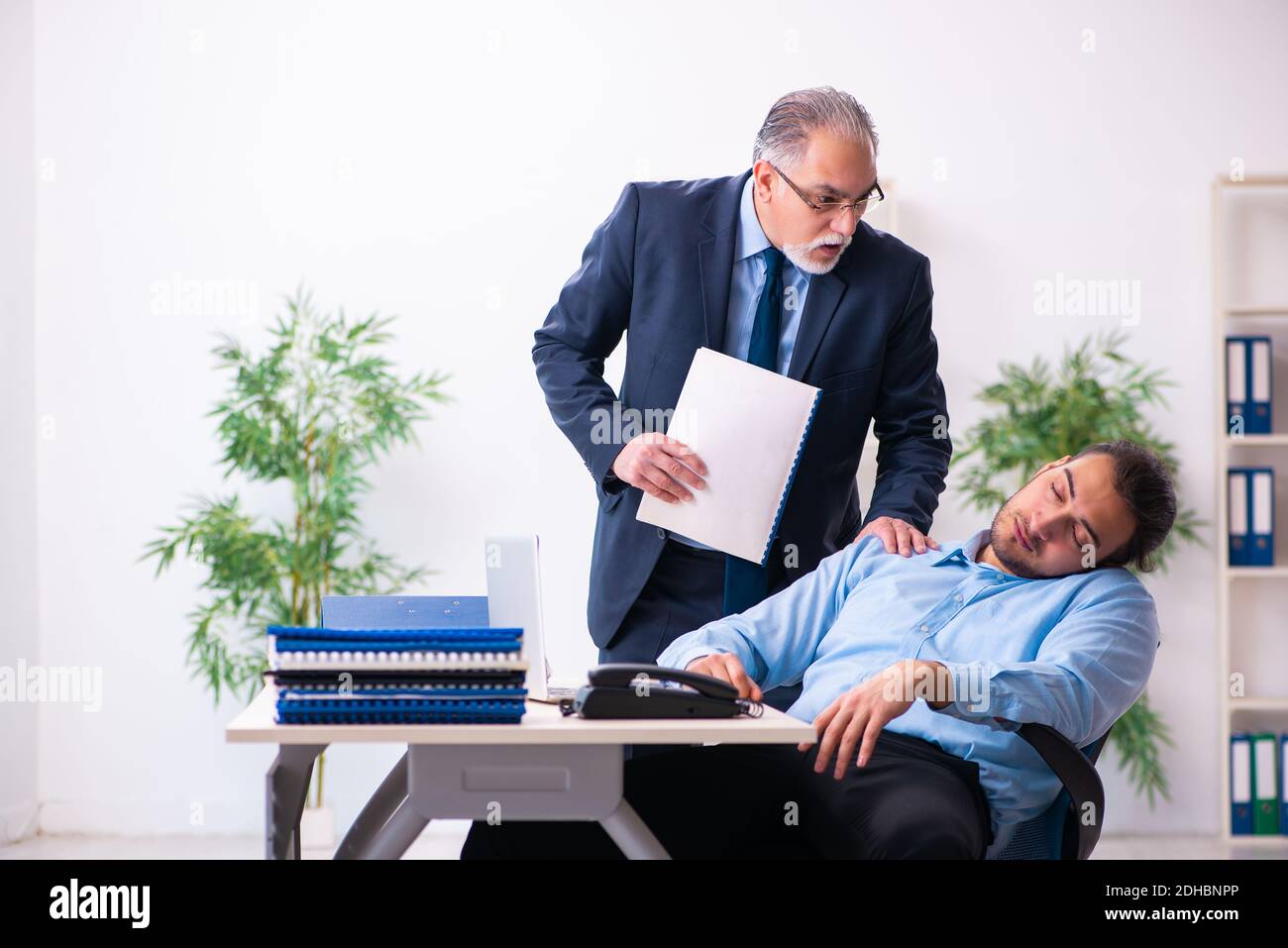 Old boss and his young assistant in the office Stock Photo - Alamy