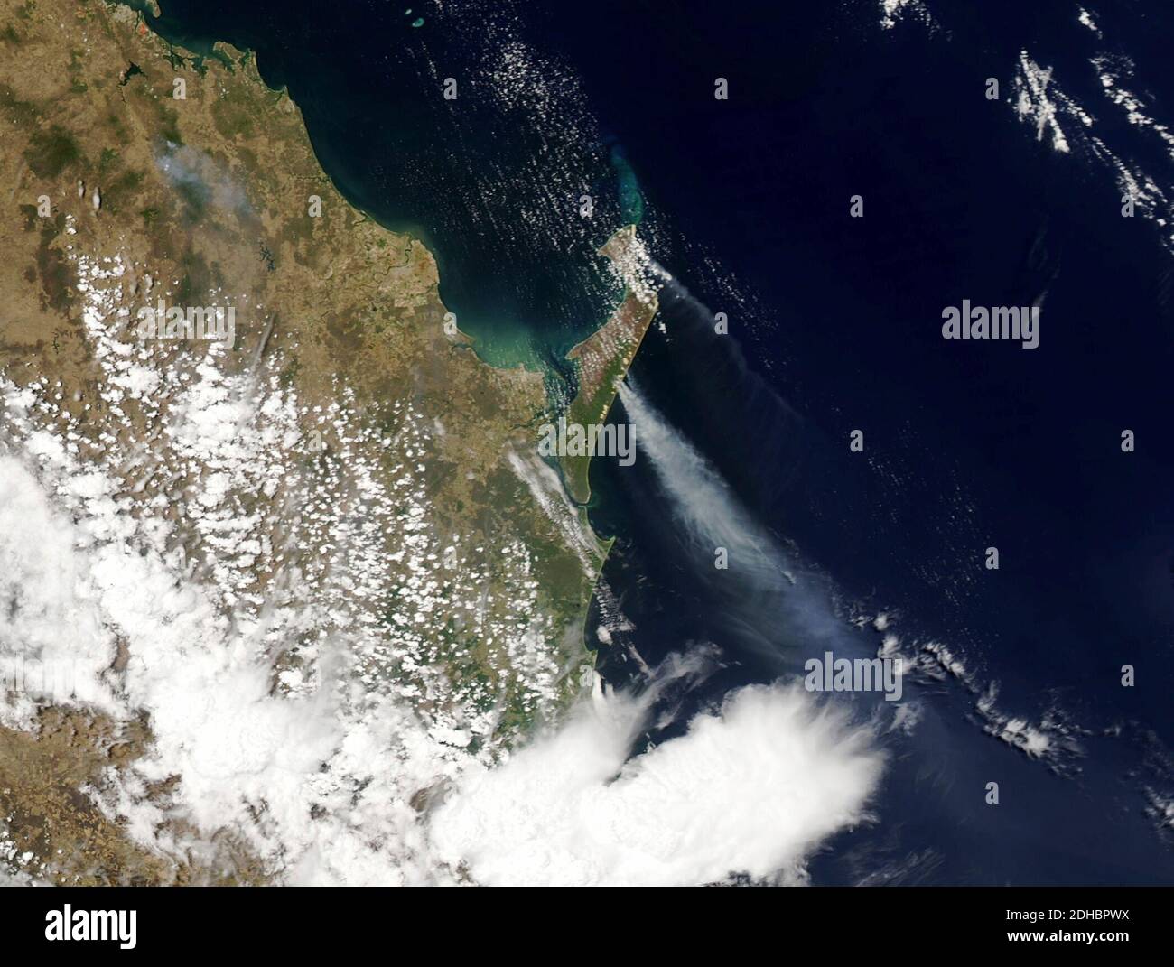 Smoke plumes rise from the eastern side of Fraser Island as observed by MODIS on board the NASA Aqua satellite December 7, 2020 on Fraser Island, Australia. An illegal campfire ignited brush and swept through the unique forests destroying half of the World Heritage Site and threatening local wildlife. Stock Photo