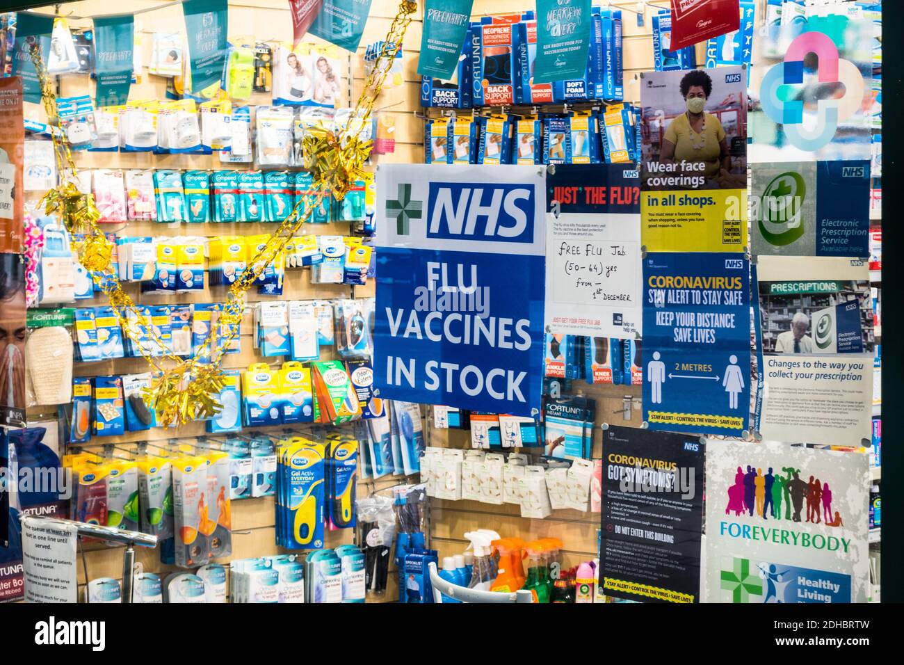 NHS Flu jab / vaccines in stock notice board on the door of an independent pharmacy shop in Barbican, London Stock Photo