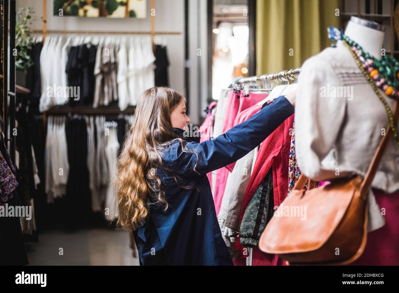 Side view of girl shopping in clothing store Stock Photo