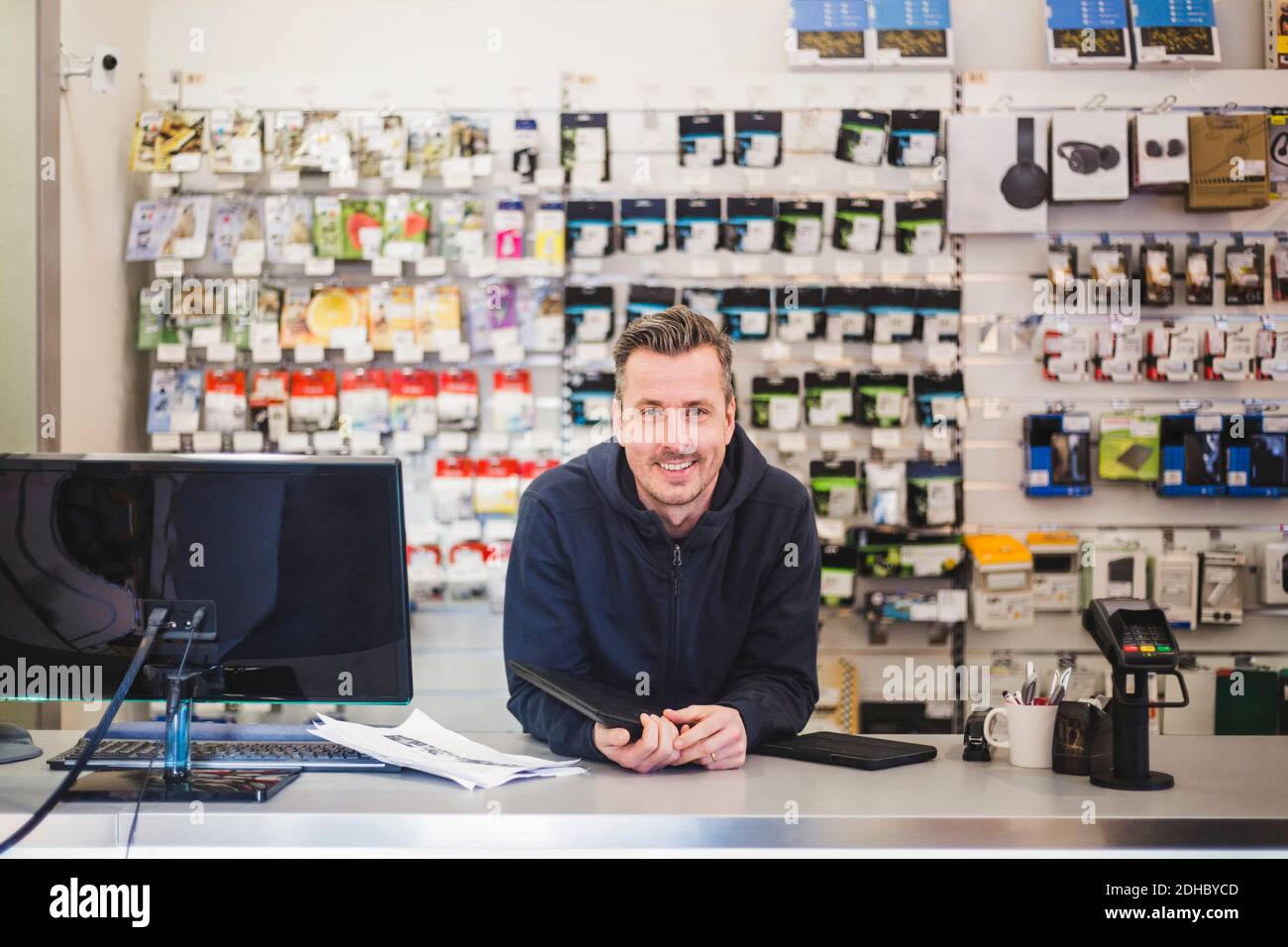 Portrait of confident smiling entrepreneur in computer store Stock Photo