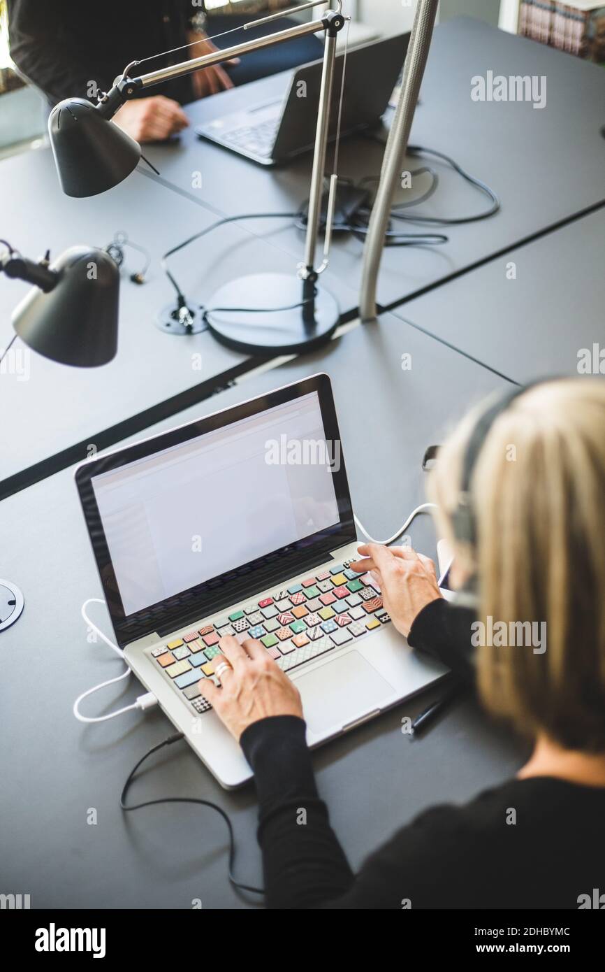 Mature woman desk typing laptop hi-res stock photography and images - Alamy