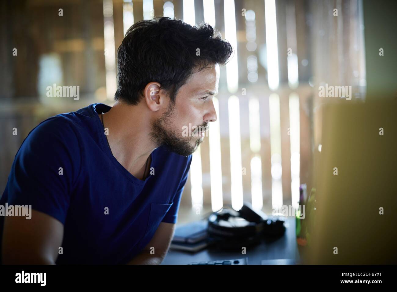 Dedicated businessman working at computer desk in office Stock Photo