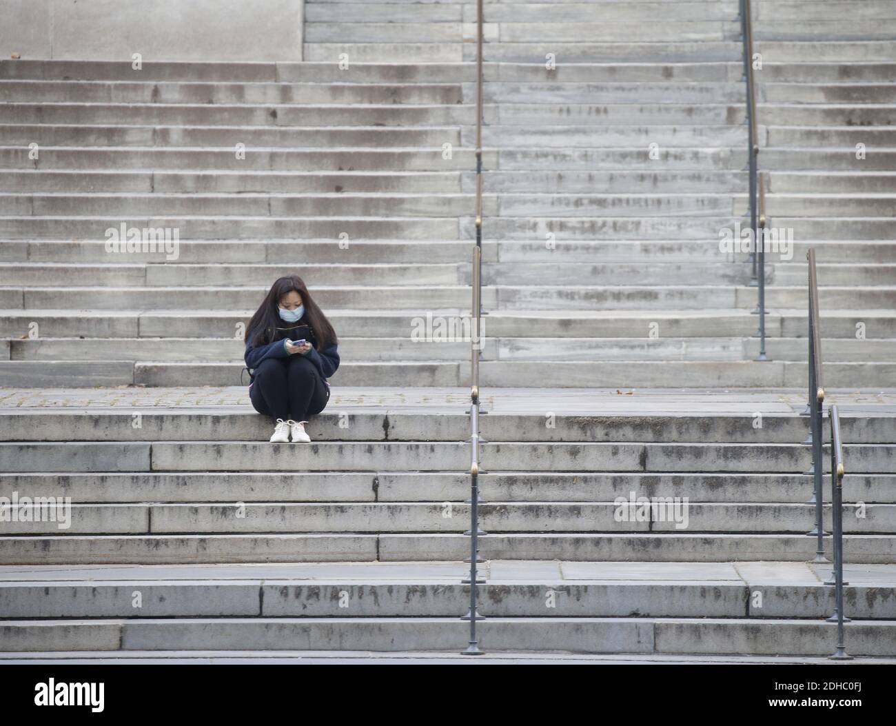 New York, United States. 10th Dec, 2020. A woman sits on the stairs to the New York Public Library wearing a face mask to protect from and prevent the spread COIVD-19 in New York City on Thursday, December 10, 2020. Photo by John Angelillo/UPI Credit: UPI/Alamy Live News Stock Photo