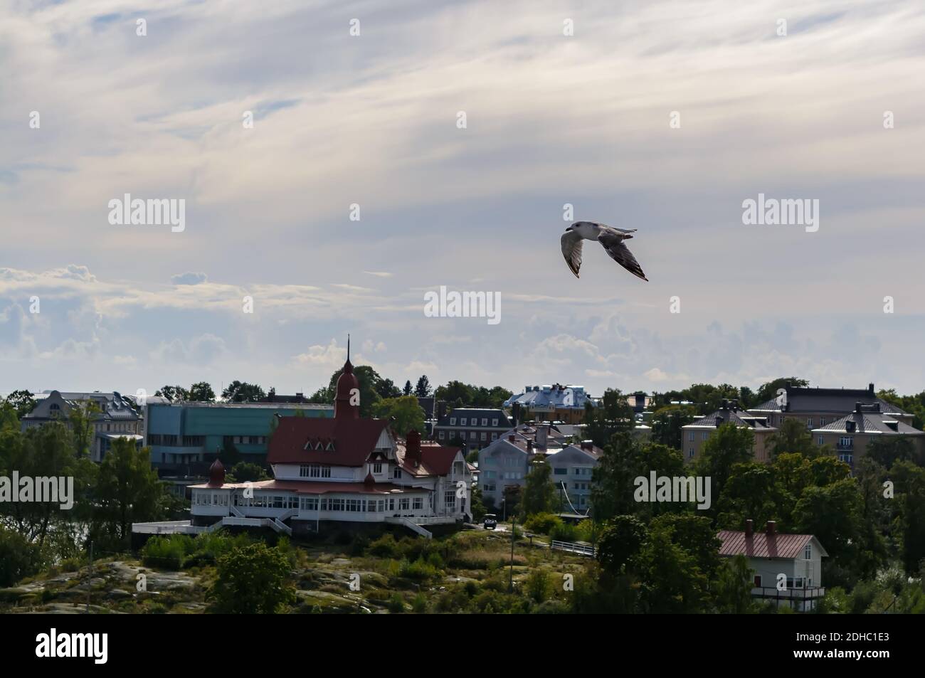 Seagull flies over Luoto island with white Art Nouveau style villa Stock Photo