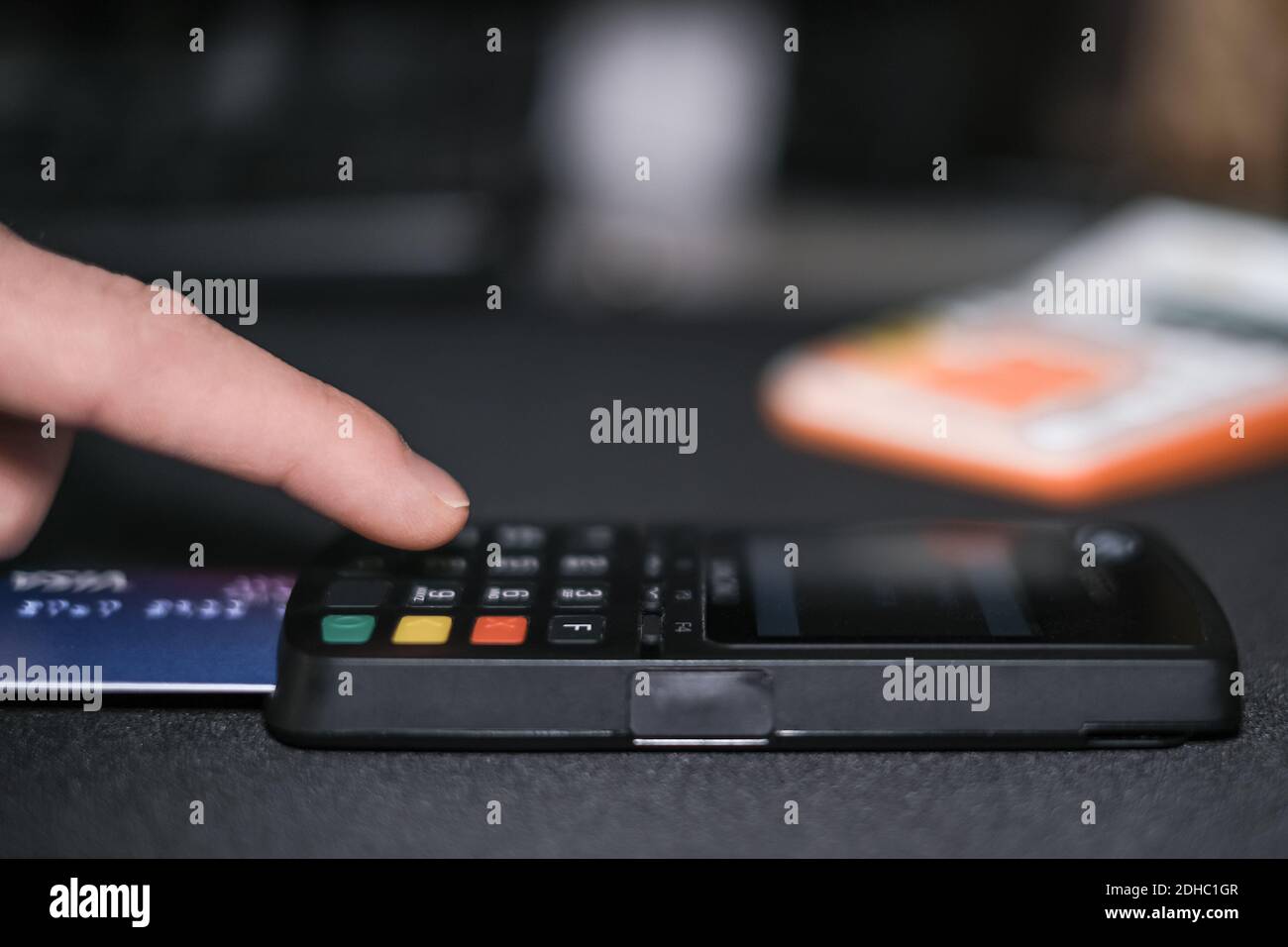 Man making purchase payment to a customer with credit card machine terminal,cashless pay Stock Photo