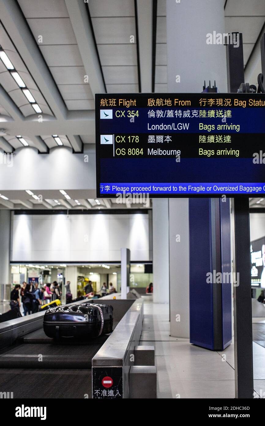 Hong Kong International Airport/Suitcase or luggage with conveyor belt in the airport. Stock Photo