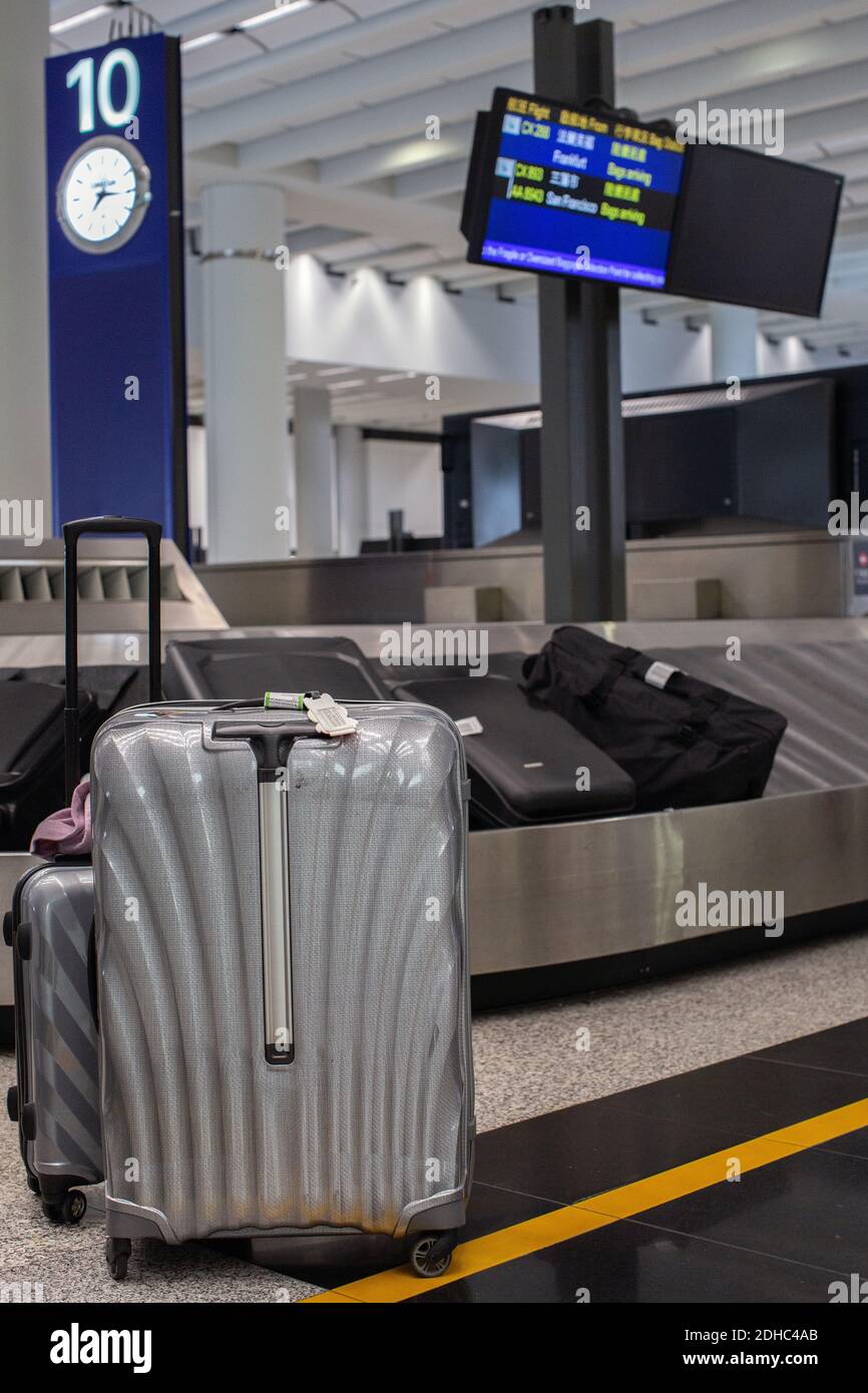 Hong Kong International Airport/Suitcase or luggage with conveyor belt in the airport. Stock Photo