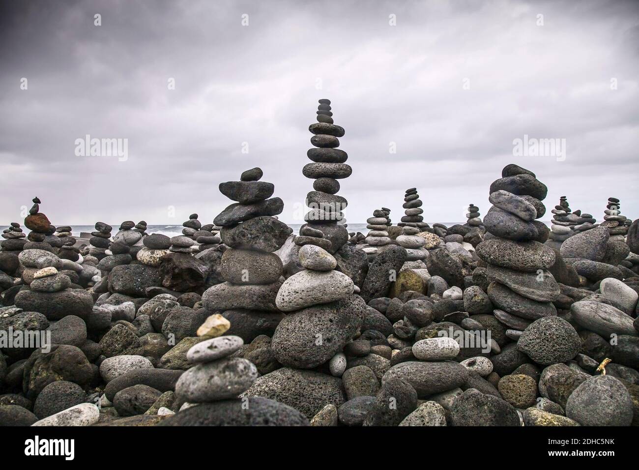 the-pebbles-stacked-on-each-other-in-a-balance-at-the-beach-stock-photo