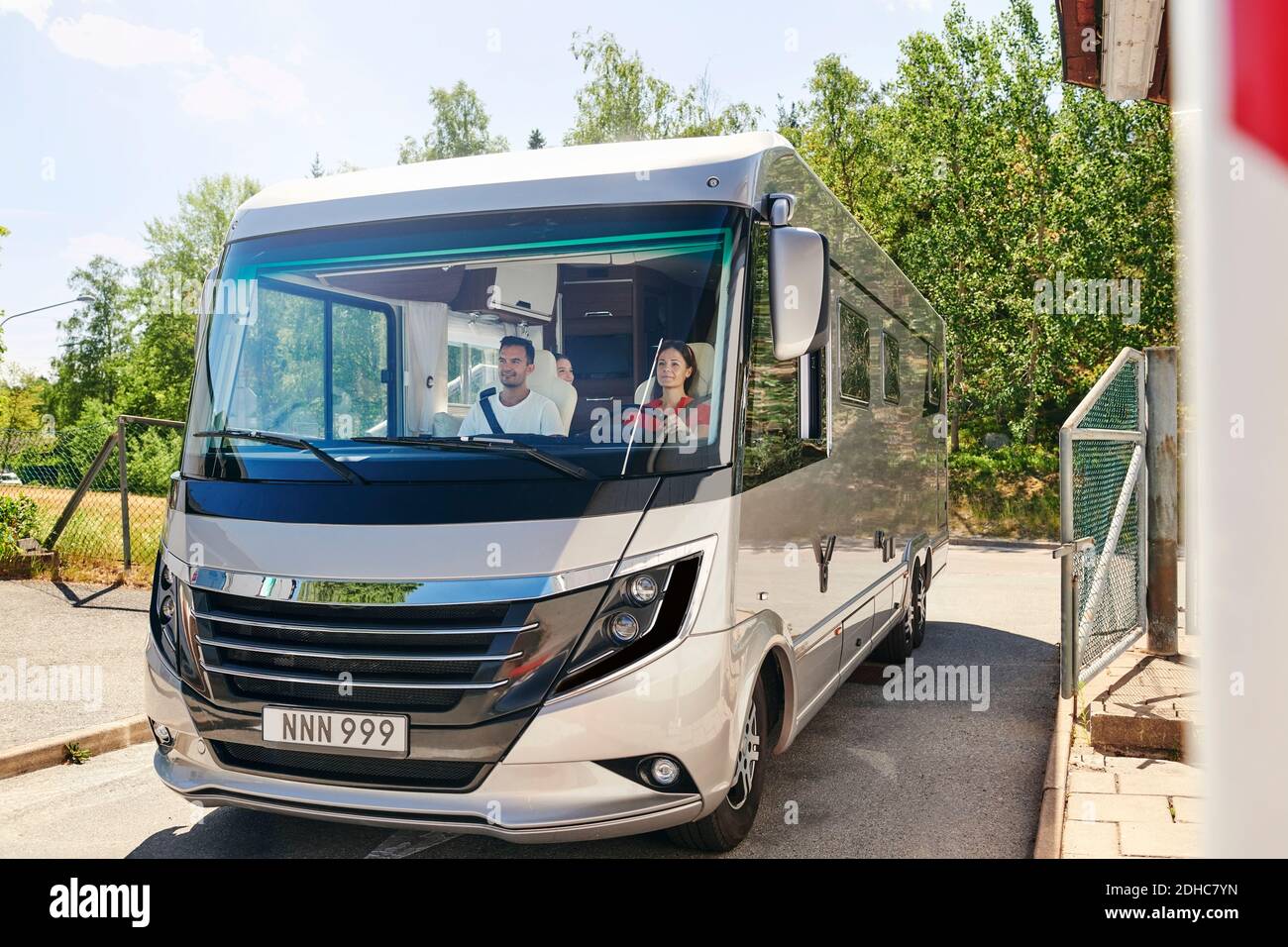 Family traveling in motor home on road during summer Stock Photo