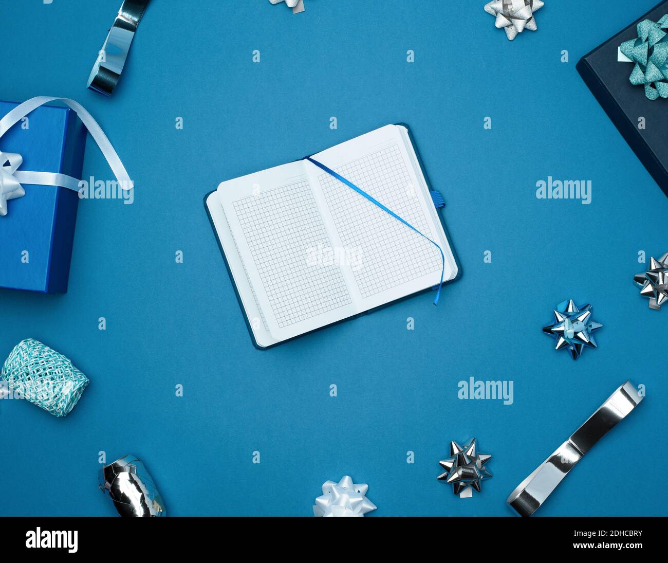 Open notebook with empty white sheets, blue background with box Stock Photo