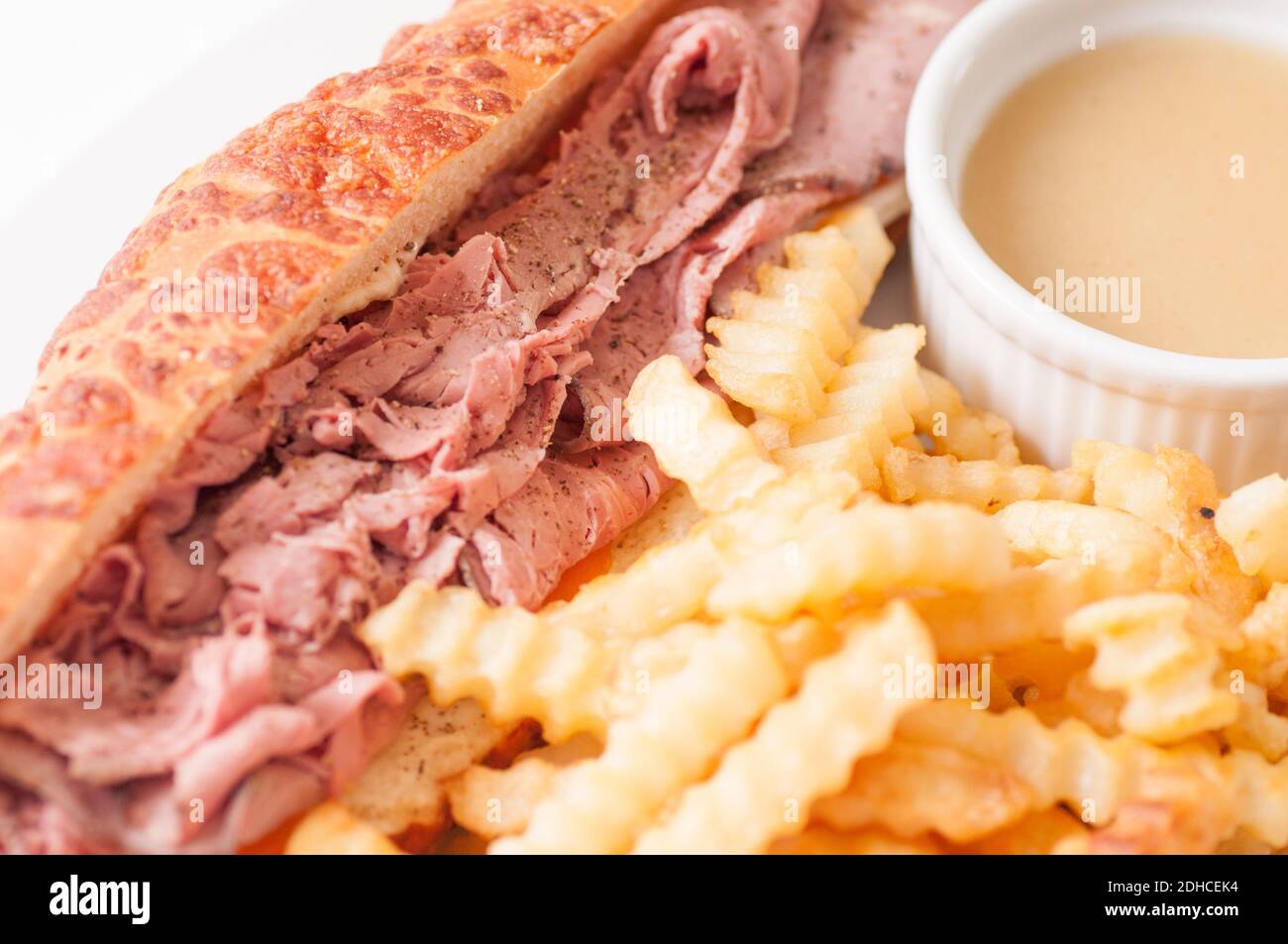 deli style sliced rare roast beef on a cheese bun with french fries and