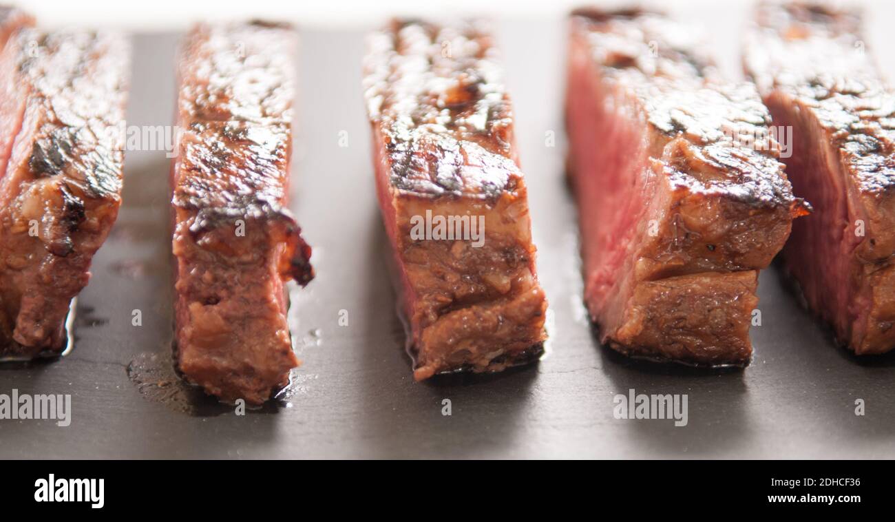 thick ribeye steak seared rare on a cast iron grill Stock Photo Alamy
