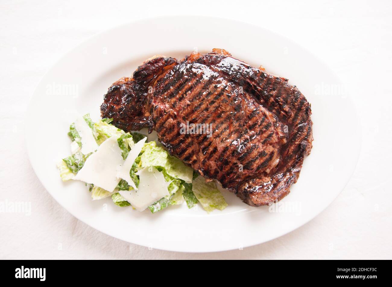 thick ribeye steak seared rare on a cast iron grill Stock Photo Alamy