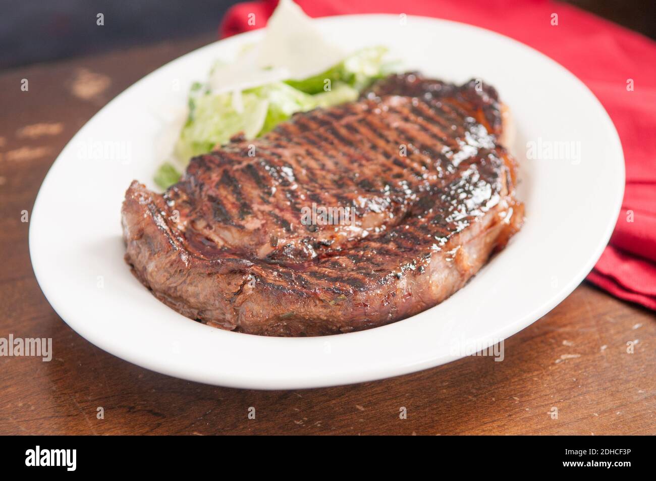 thick ribeye steak seared rare on a cast iron grill Stock Photo Alamy