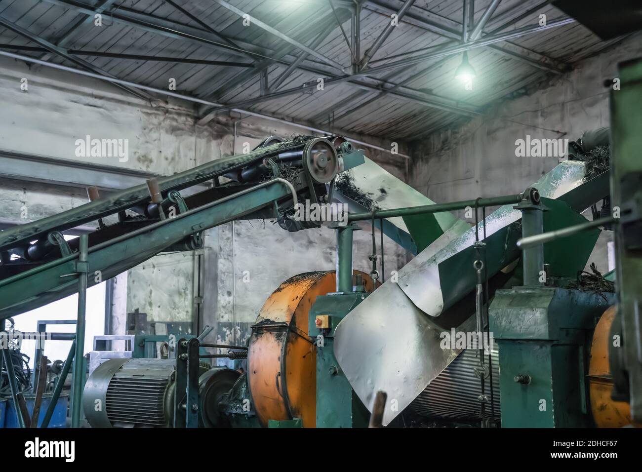 Rubber recycling processing factory, industrial equipment and conveyor line with cut used car tires. Recycling waste. Stock Photo