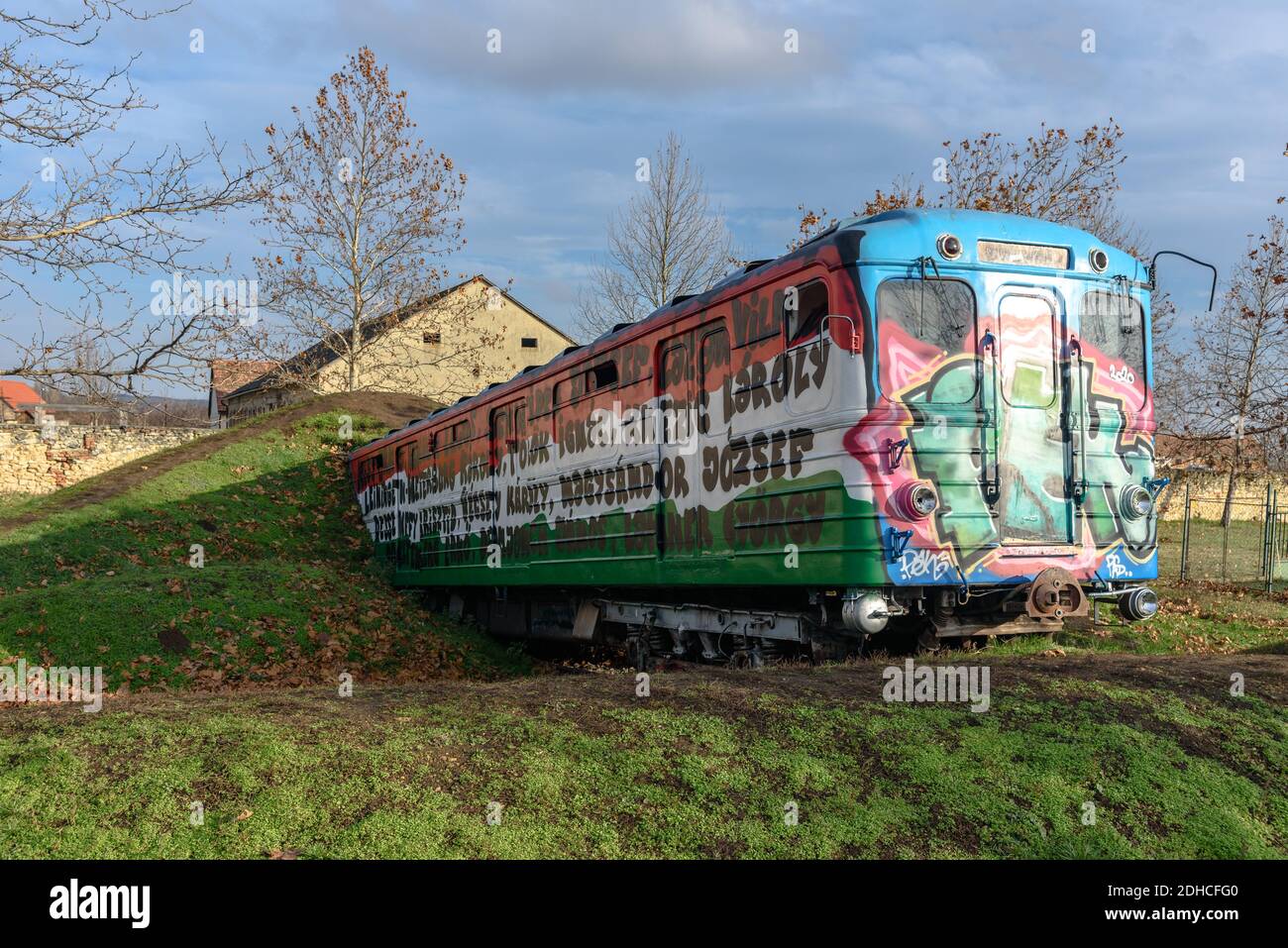 'A földből kitörő metrókocsi' by Ildiko Zsemlye in Csakbereny, Hungary features a Metrowagonmash Ev3 metro car emerging from the ground Stock Photo