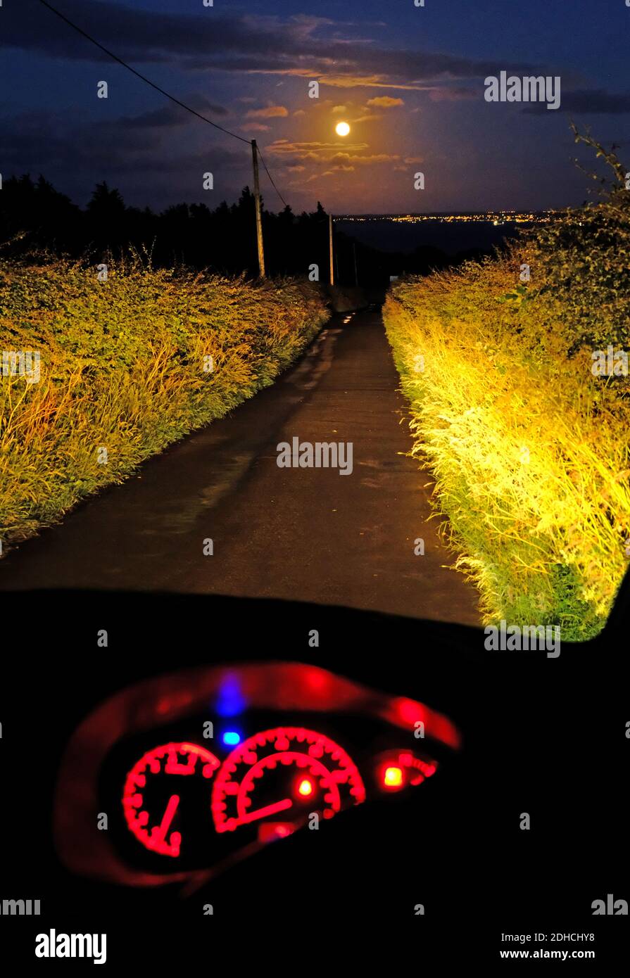 Full Moon, full beam, on a country road, County Antrim Stock Photo