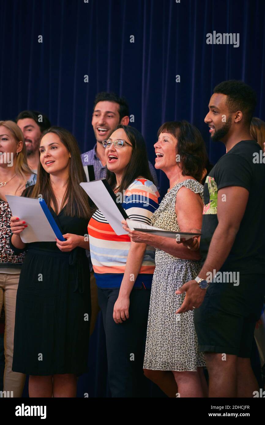 Multi-ethnic people singing in choir on school stage Stock Photo - Alamy