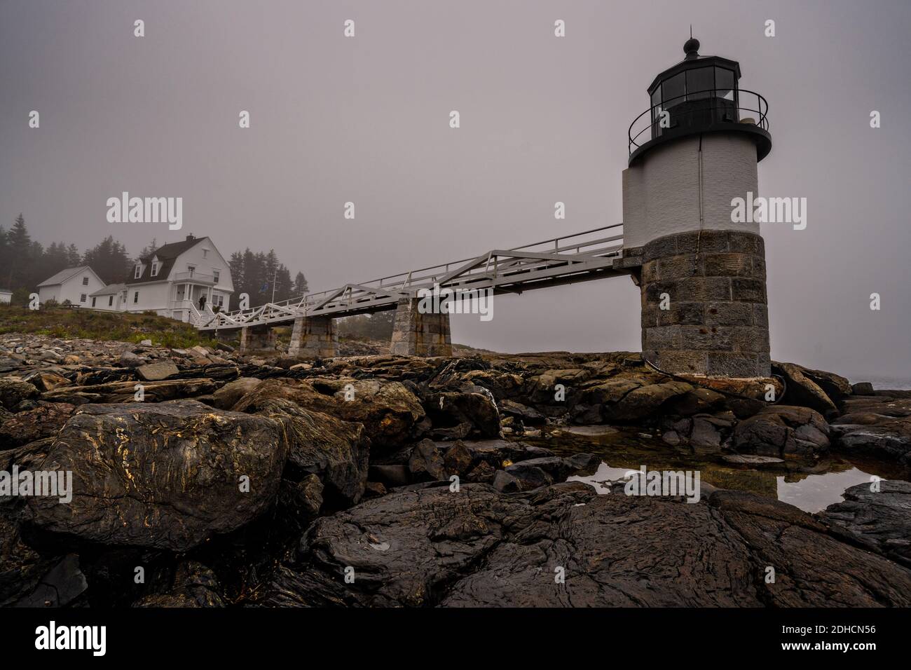 Fog descends over the Marshall Point Lighthouse near Port Clyde, Maine. The  current lighthouse was built in 1832 on a rocky point of land near the  mouth of Port Clyde Harbor and, image size:1300x956