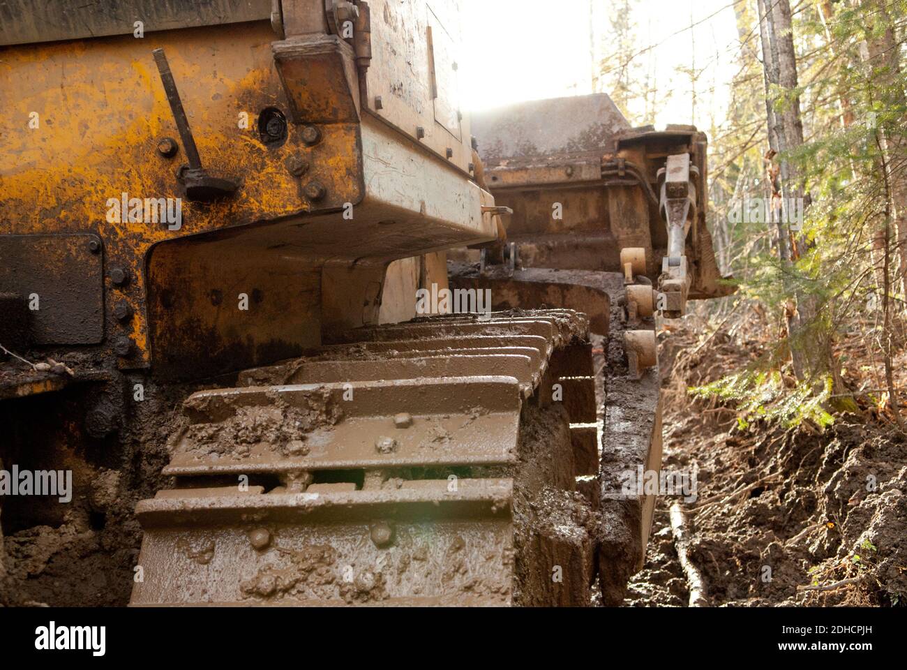 large bulldozer pulling my truck out of the mud Stock Photo