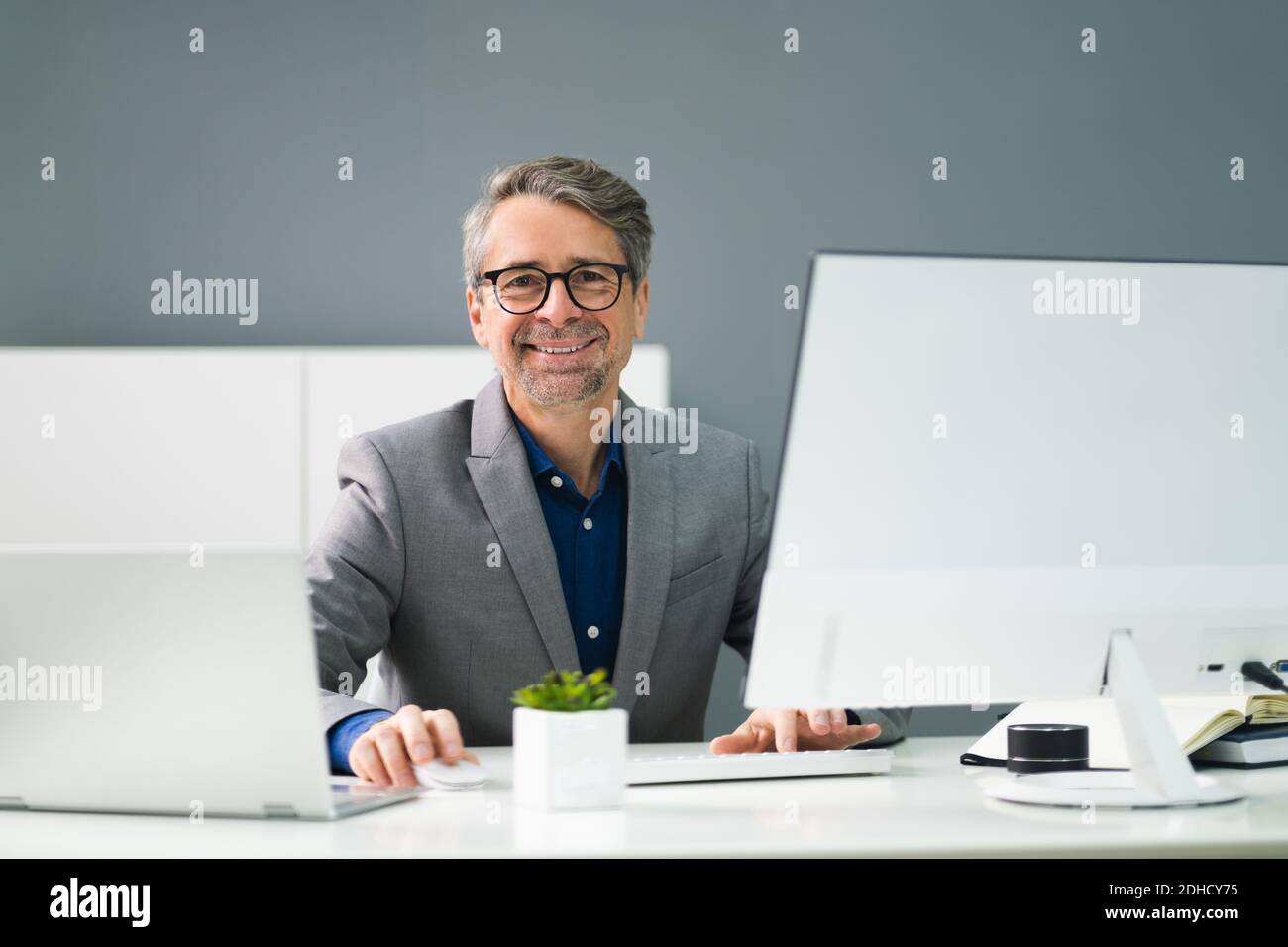 Happy Professional Man Employee Using Computer For Work Stock Photo