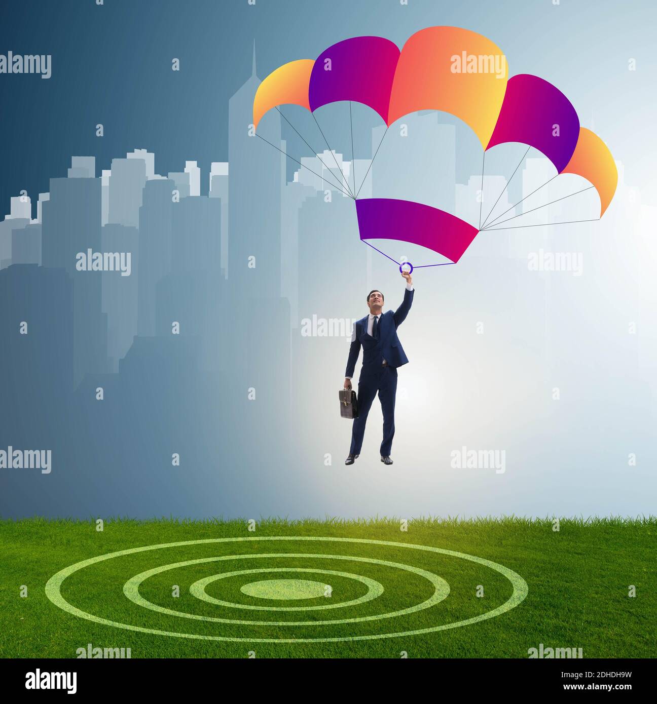 Young businessman falling on parachute in business concept Stock Photo