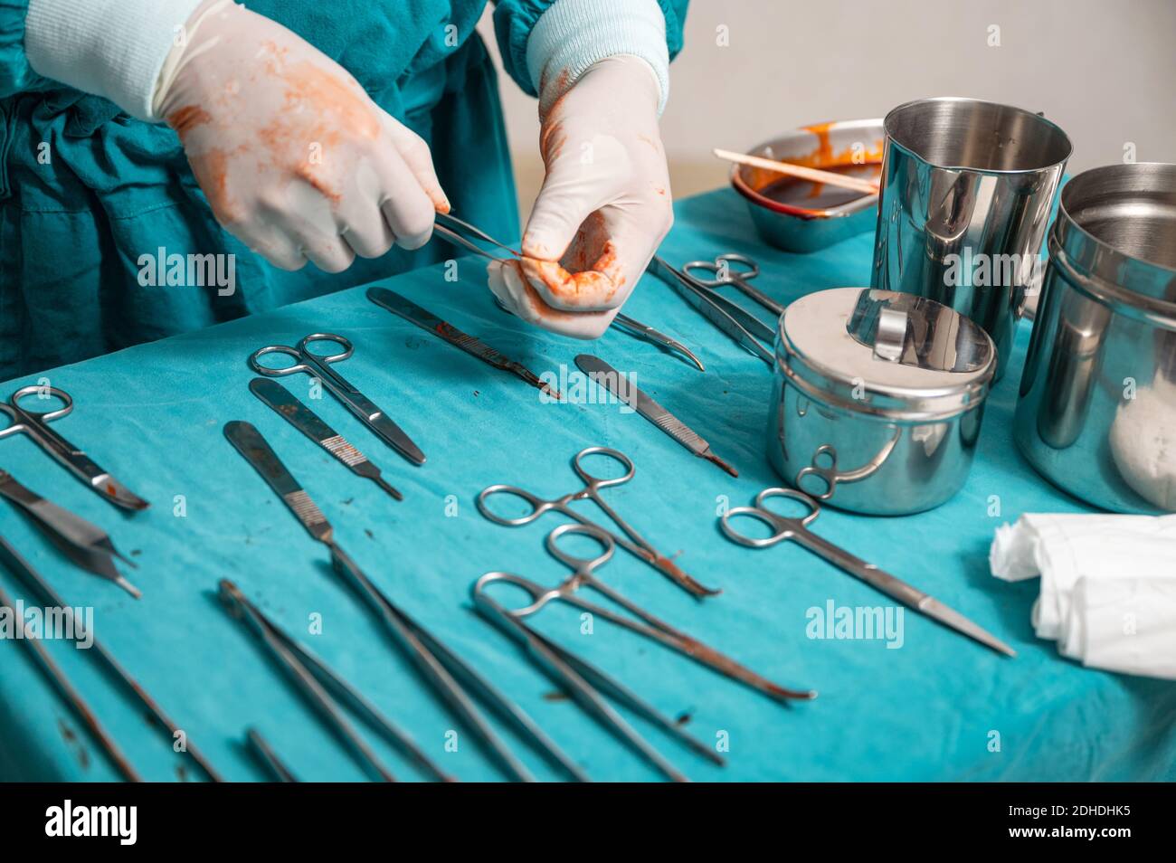 Surgeon hand wear medical gloves choosing surgical instruments on a