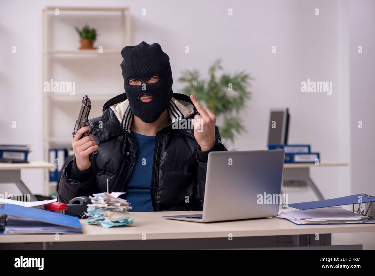 Young male burglar in the office Stock Photo