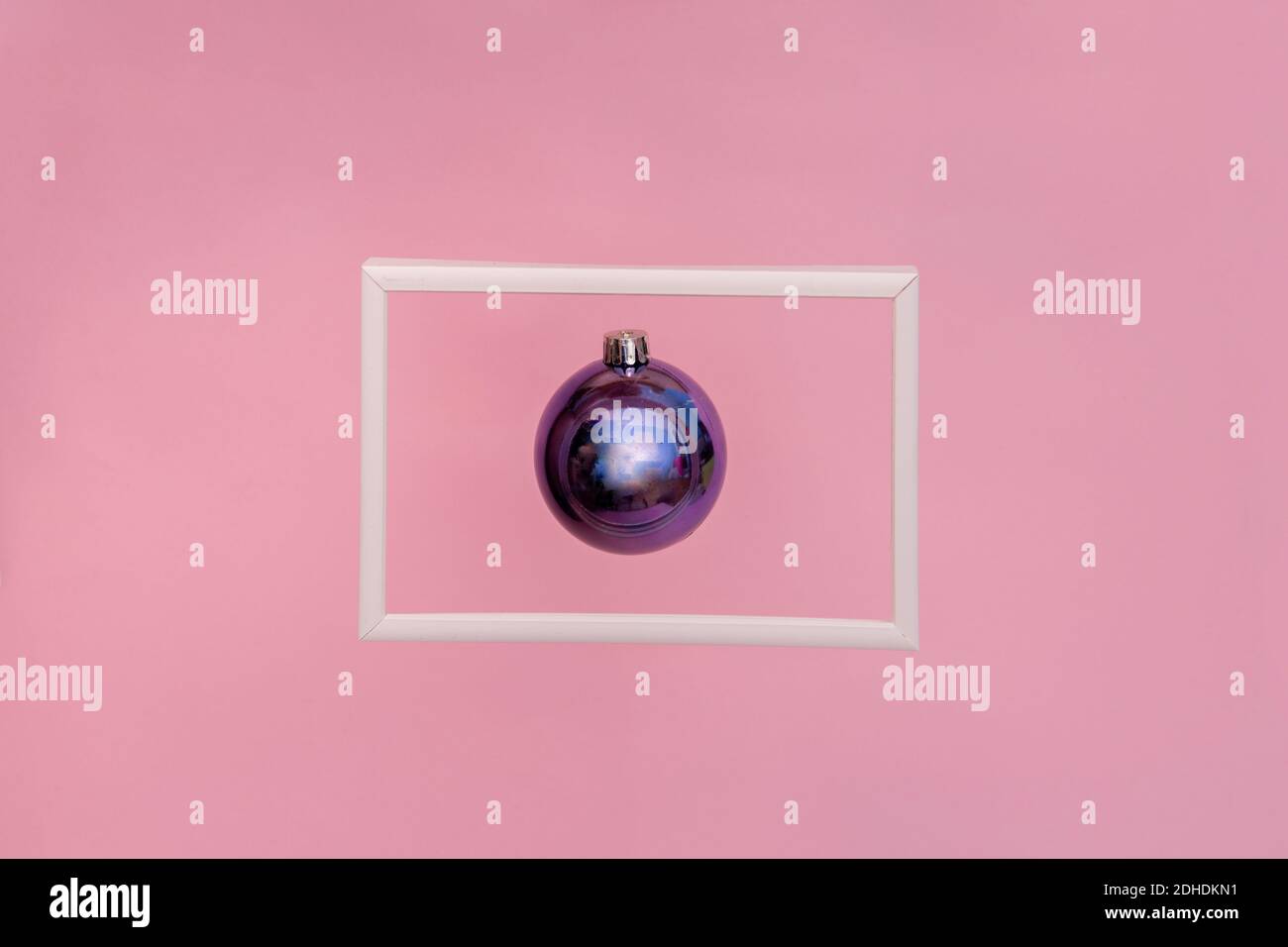 Christmas purple bauble floating in a picture frame. Abstract Christmas background Stock Photo