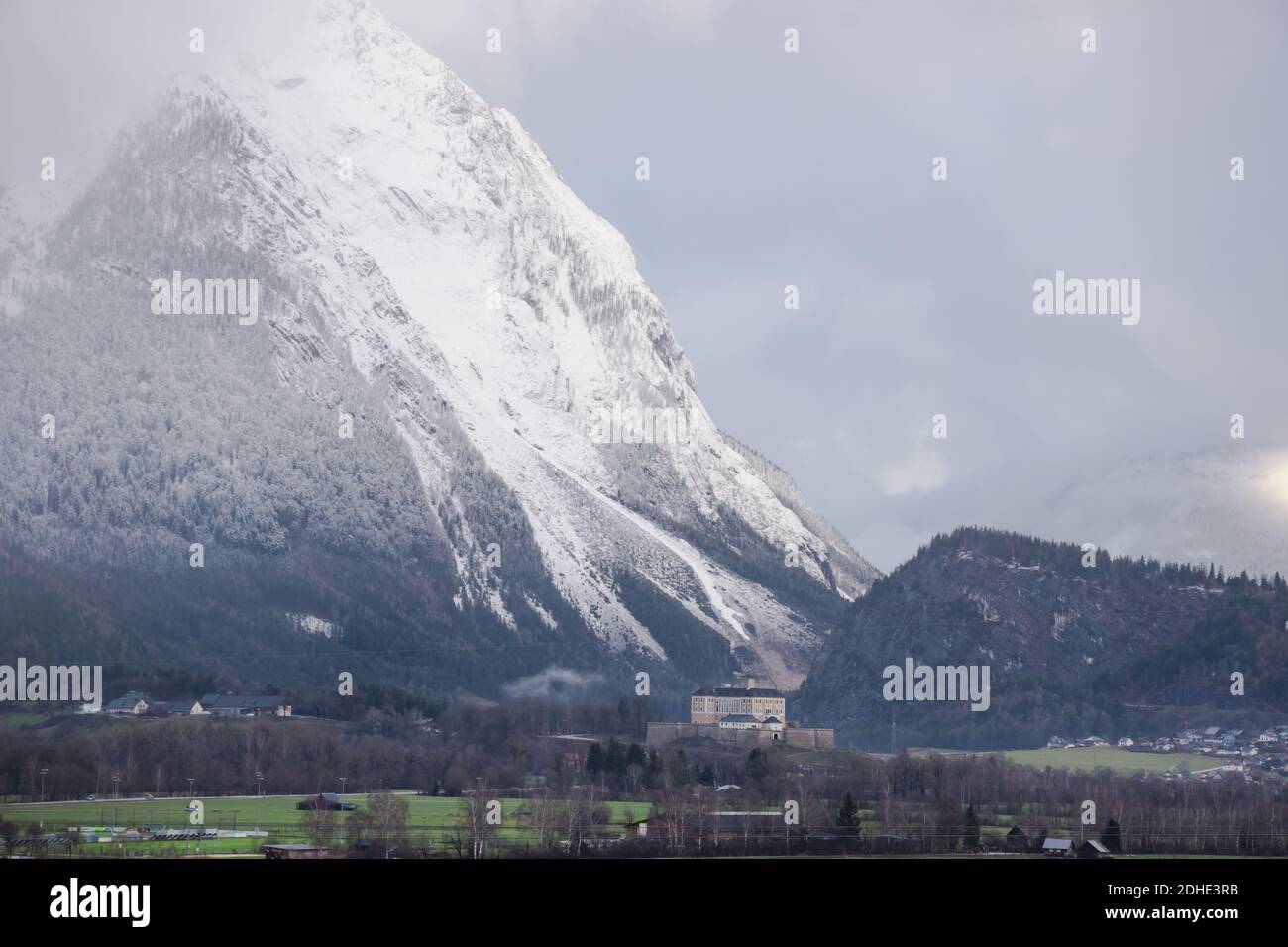Winter landscape with snow covered Grimming mountain and Trautenfels Castle in the district of Liezen in Styria, Austria Stock Photo