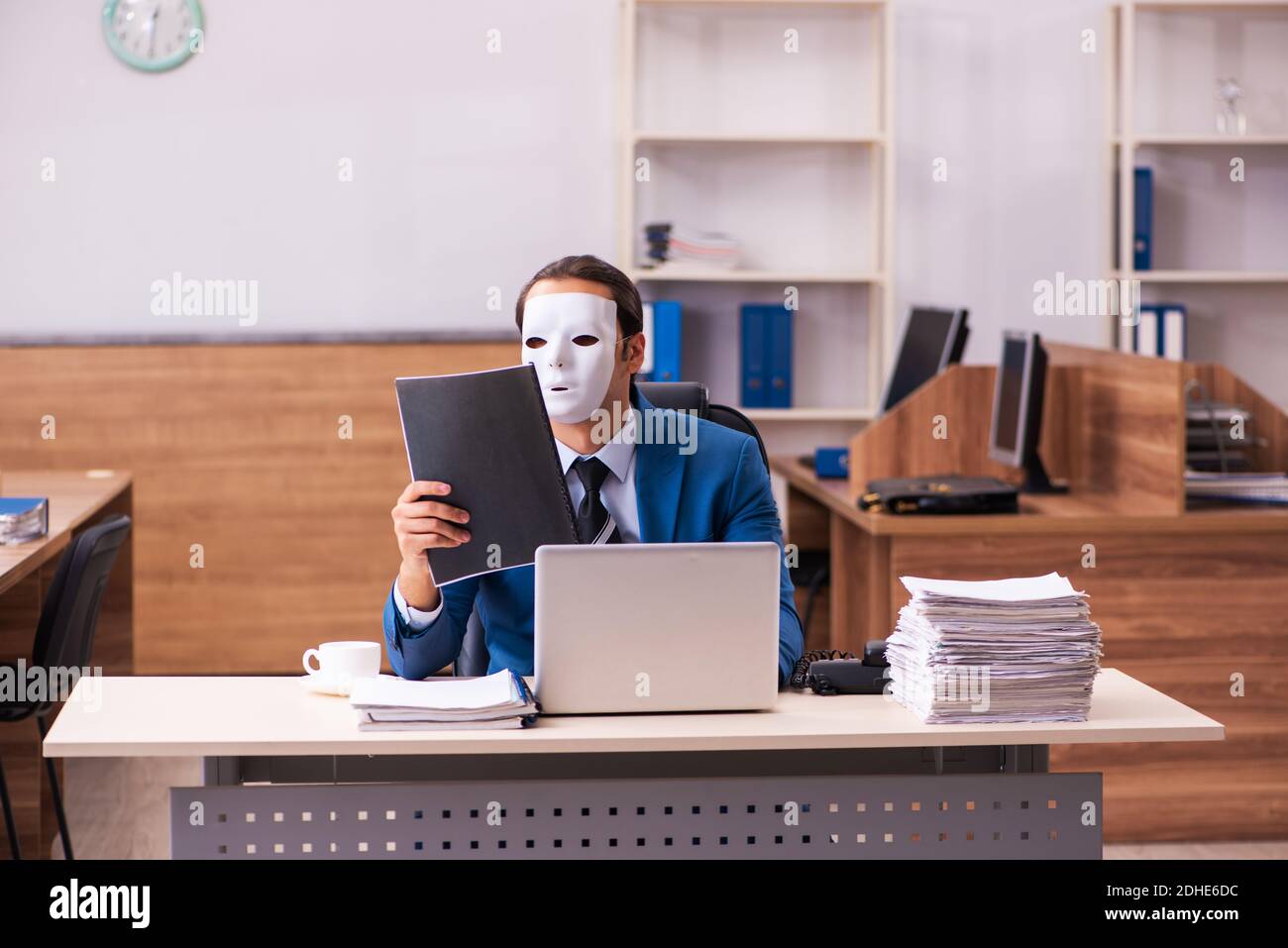 Young male employee wearing masks in the office Stock Photo