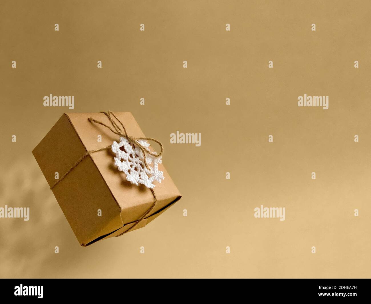 levitating gift in craft wrapper, natural rope, crocheted snowflake ...